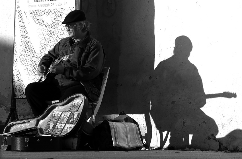 Shadowed street musician by Mili
